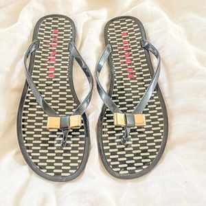 Coach Jelly flip flops black and white gold bow